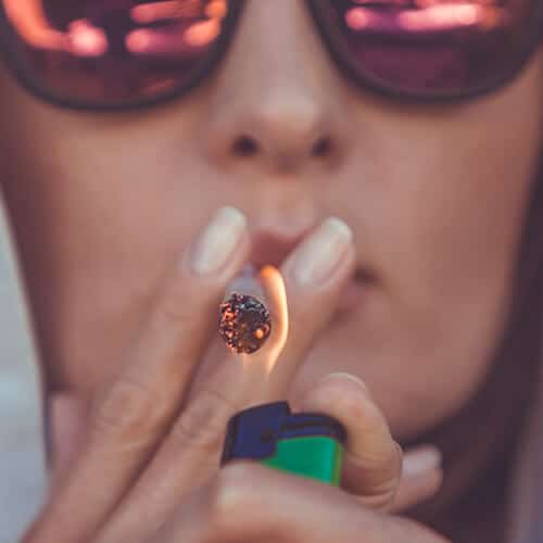 Smoking marijuana with red glasses