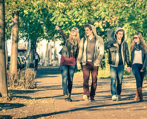 Group Of Teenagers Walking In The Street